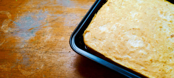 istock Steamed or baked dough cooked in a square iron container on a wooden table. 1347626959