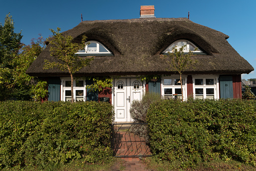 BORN ON DARSS, GERMANY - OCTOBER 06, 2021: The village is known for its picturesque colorful thatched roof houses with traditional motifs.