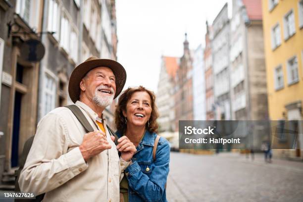 Portrait Of Happy Senior Couple Tourists Outdoors In Historic Town Stock Photo - Download Image Now