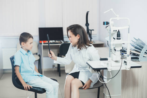 istock ophthalmologist checks the boy's vision. Vision tests in children. Hyperopia 1347627635