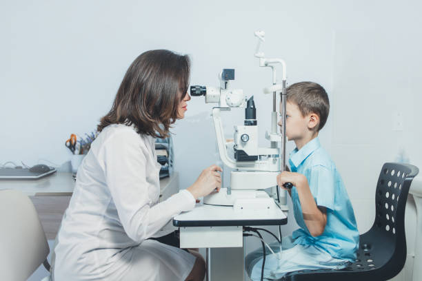 istock ophthalmologist checks the boy's vision. Vision tests in children. Hyperopia 1347627671