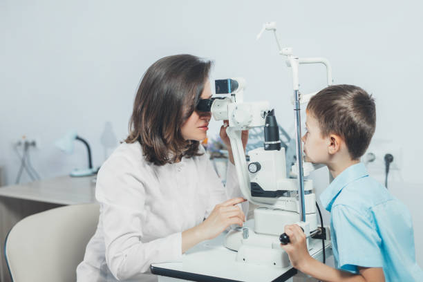 istock ophthalmologist checks the boy's vision. Vision tests in children. Hyperopia 1347628364