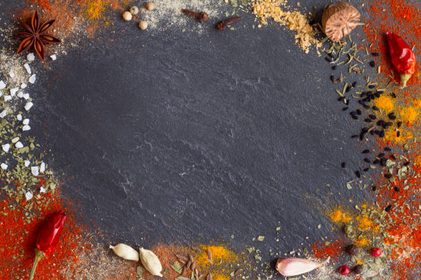 istock Variety aromatic spices in powder scattered on black stone background with free space 1347628406