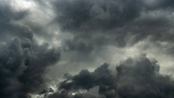 istock gray stormy dramatic sky with overcast and heavy textured cumulus clouds and backlight. large panoramic view 1347628411
