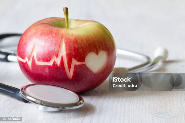 Heartbeat Line On Red Apple And Stethoscope Healthy Heart Diet Concept Stock Photo - Download Image Now