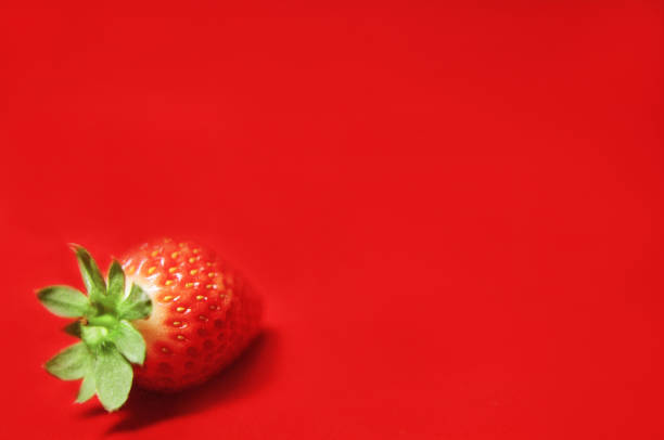 a strawberry on the red backgorund