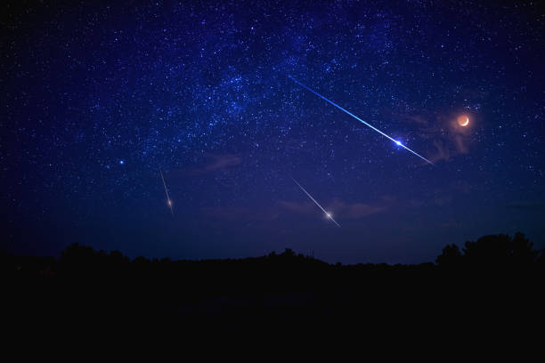 istock Landscape silhouette of a evening sky with crescent Moon eclipse, meteor, shooting star and planets. 1347634552