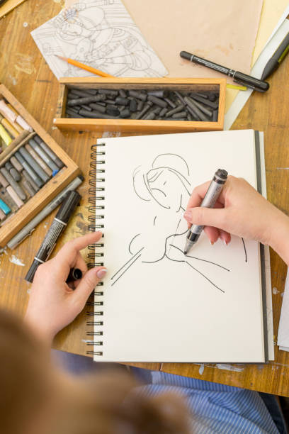 young artist makes a sketch with watercolor marker on paper - drawing sketch artist charcoal drawing imagens e fotografias de stock