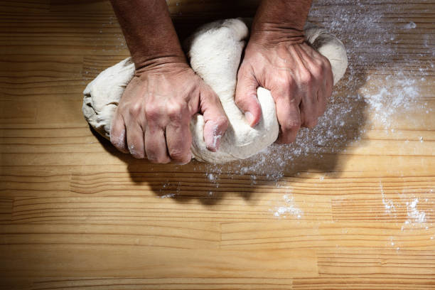 baker hands kneading the dough for bread or pizza on wooden worktop, top view, space for text. - wheat pasta flour italy imagens e fotografias de stock