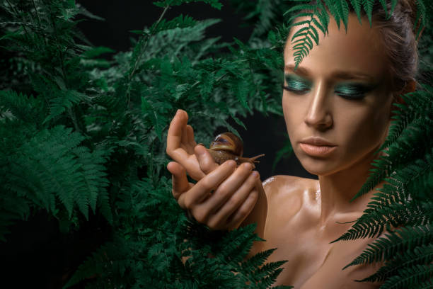 istock Mother Nature figure with snails 1347639891