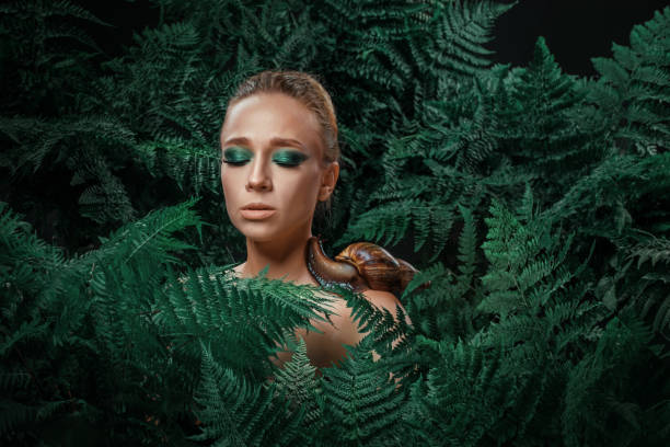 istock Mother Nature figure with snails 1347639916