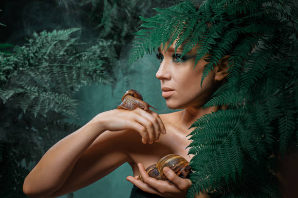 istock Mother Nature figure with snails 1347639930