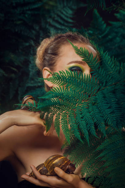 istock Mother Nature figure with snails 1347639953