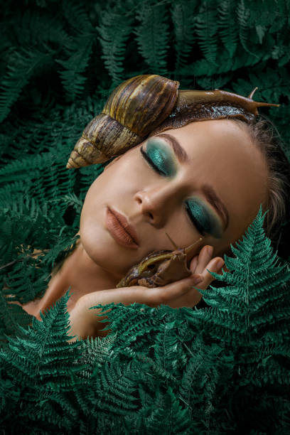 istock Mother Nature figure with snails 1347640523