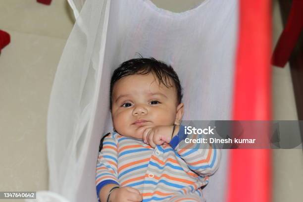 An Indian Little Newborn Innocent Baby Lying In The Crib Stock Photo - Download Image Now