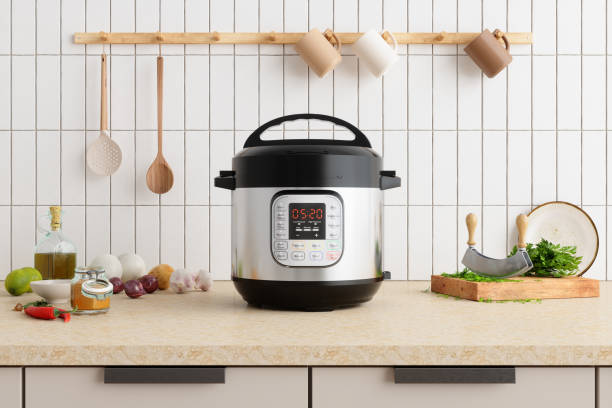 양파, 마늘, 식용유 및 도마가있는 주방 카운터의 멀티 밥솥 - crock pot 뉴스 사진 이미지