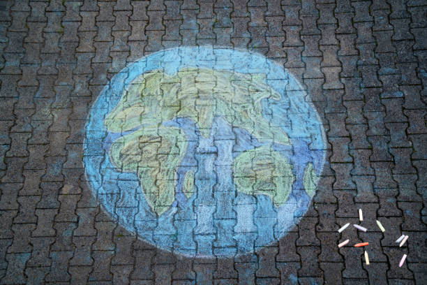 istock Earth globe painting with colorful chalks on ground. PHappy earth day concept. Creation of children for saving world, environment and ecology. 1347641841