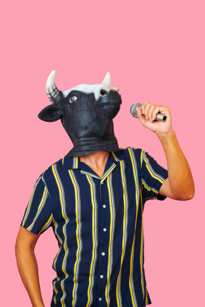 istock man wearing a cow mask speaking into a microphone 1347642474