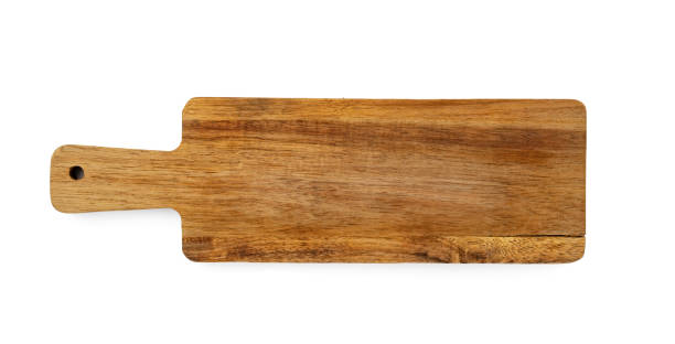 istock Dark wooden cutting board on white background 1347644796