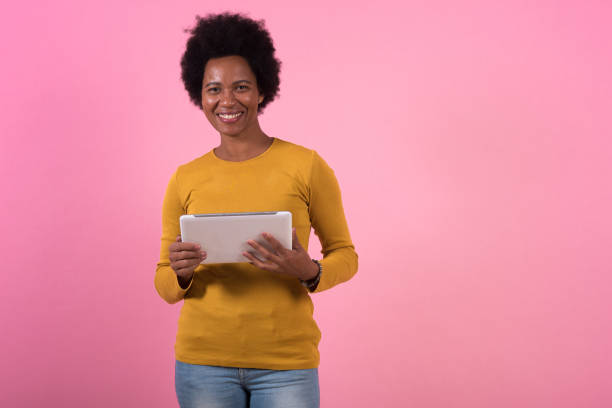 istock Studio portrait of an Afro woman using digital tablet 1347646480