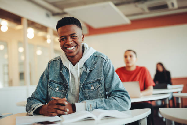 istock Portrait of smiling boy in university classroom 1347651750