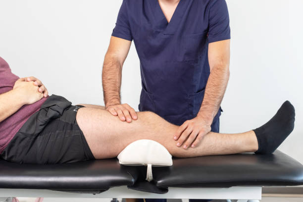 istock Physiotherapist performing a knee exercise for a patient 1347653324