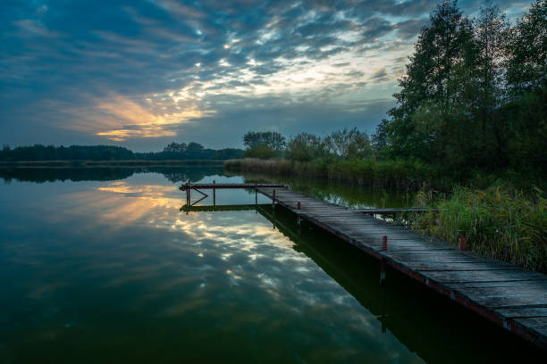 istock Pier over the lake and the sunset behind the clouds 1347654883