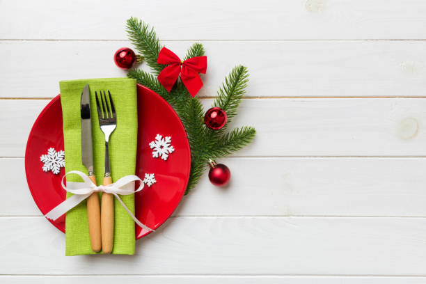istock Christmas table place setting with christmas decor and plates, kine, fork and spoon. Christmas holiday background. Top view with copy space 1347655296