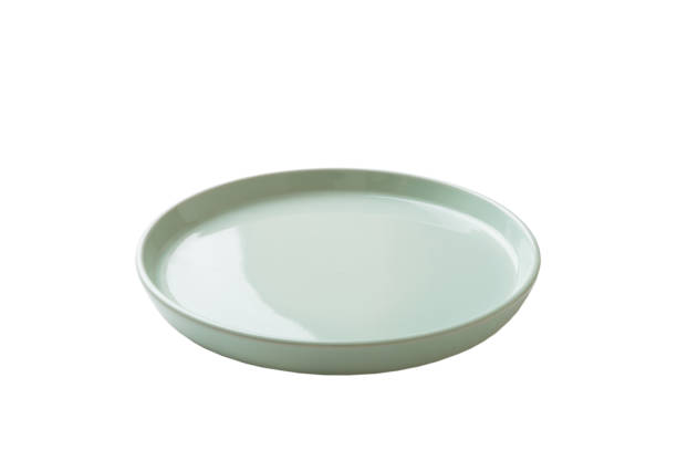 istock Blue ceramic round plate isolated over white background. perspective view 1347655374