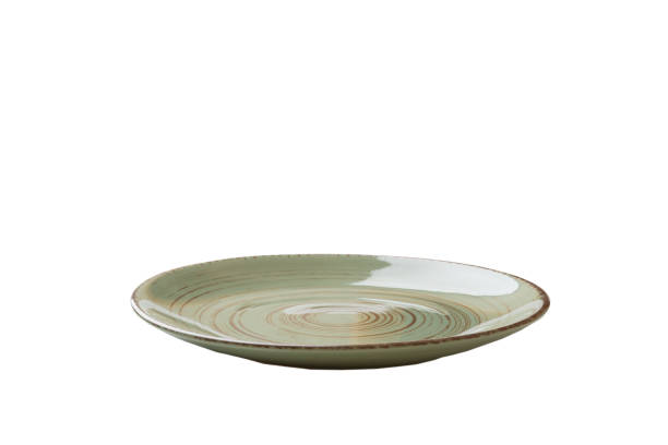 istock Green ceramic round plate isolated over white background. perspective view 1347655376