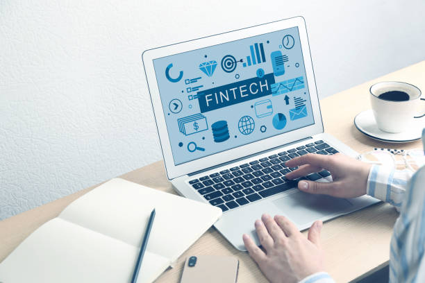 istock Woman using laptop with word FINTECH in office, closeup 1347656402