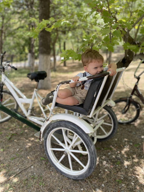 istock Little boy sitting on the old retro bicycle 1347657847
