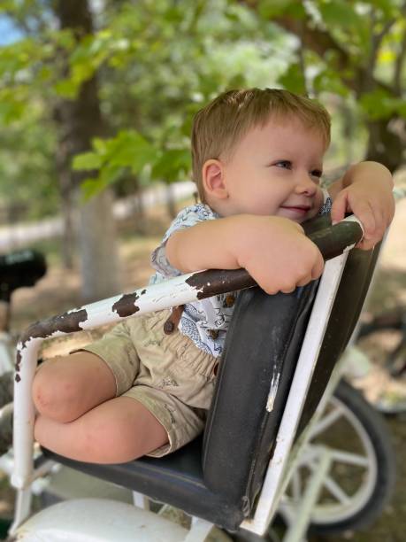 istock Little boy sitting on the old retro bicycle 1347657852