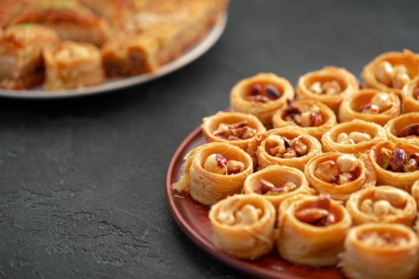 istock Delicious baklava dessert in oriental setting on black background 1347658734