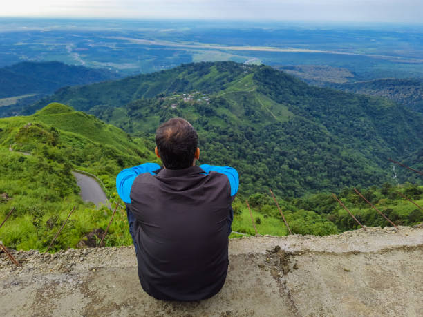 istock man standing at mountain top with dramatic sky at morning 1347658853