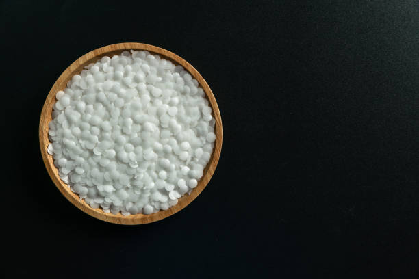istock White plastic beads on wood  background, Polymers bead or polymer resin, polymer pallet, Product from petrochemical plants. granules polymer, 1347659077
