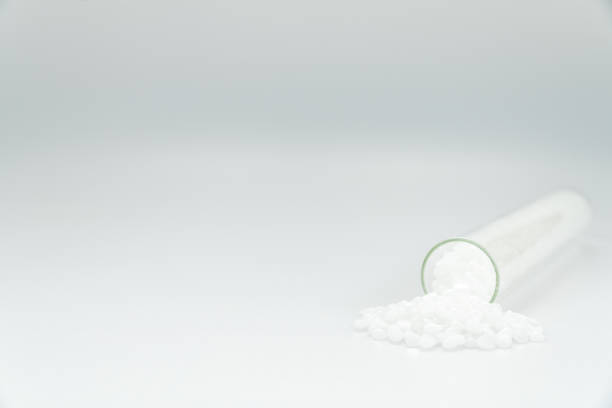 istock White plastic beads on wood  background, Polymers bead or polymer resin, polymer pallet, Product from petrochemical plants. granules polymer, 1347659097