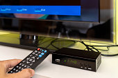 Digital decoder with remote control and television monitor.