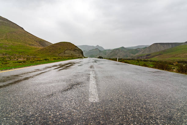 istock Wet asphalt road in mountainous area 1347663465