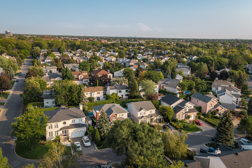 Aerial view of houses and streets in beautiful residential neighbourhood in Montreal, Quebec, Canada, North America. Property, housing and real estate concept, summer season.