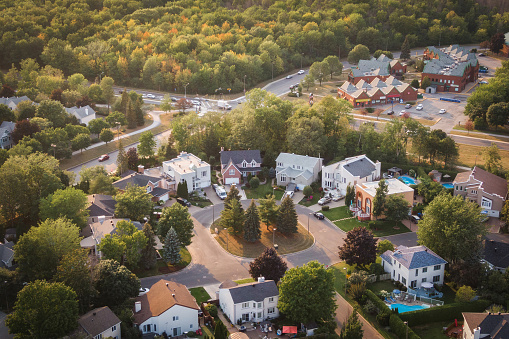 Aerial view of houses and streets in beautiful residential neighbourhood at sunset in Montreal, Quebec, Canada, North America. Property, homes and real estate concept, summer season.
