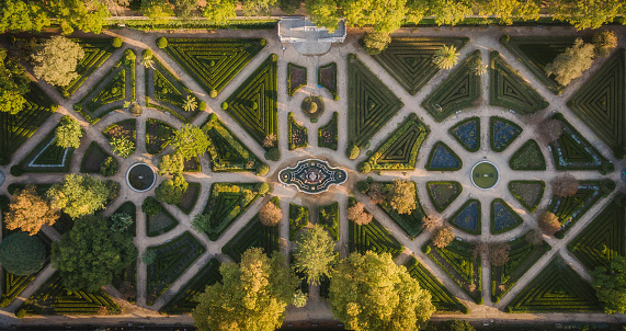 Top down aerial view of beautiful park and botanical garden at sunrise in Lisbon, Portugal.