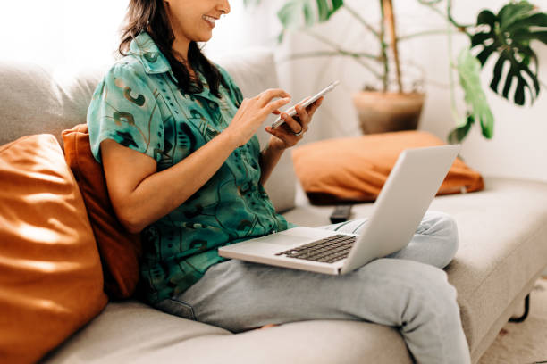 istock Young woman surfing the net at home 1347668221