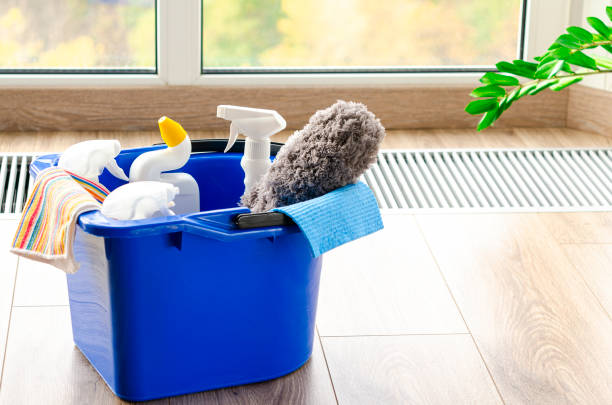 istock Household cleaners on wooden floor on panoramic window background 1347668634