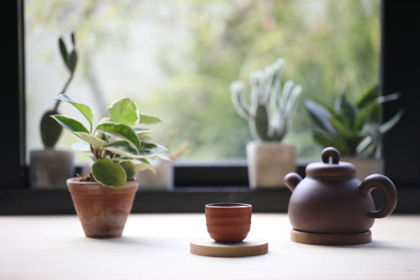 istock Wooden tea cup with tea pot and notebook with plant pot 1347670464