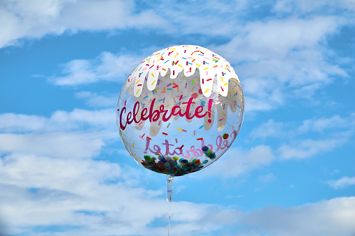 Celebrate balloon flying on blue sky
