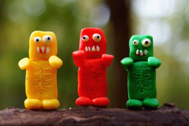 istock Three funny colorful zombies. Halloween decorations. 1347673780