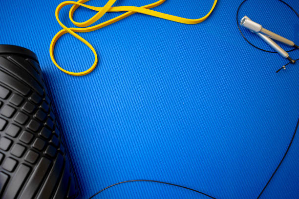 istock Sport fitness foam roller on blue mat 1347677640