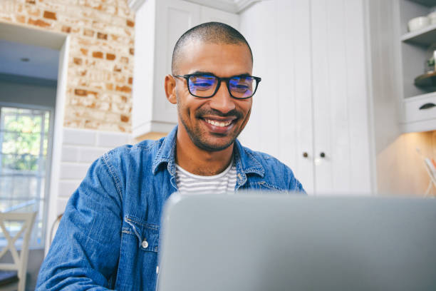 istock Shot of a young man using a laptop while working at home 1347679939