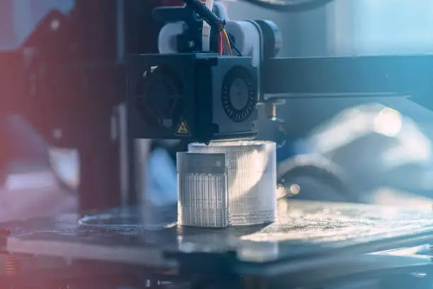 The 3D printer prints white transparent plastic model. modern technology
